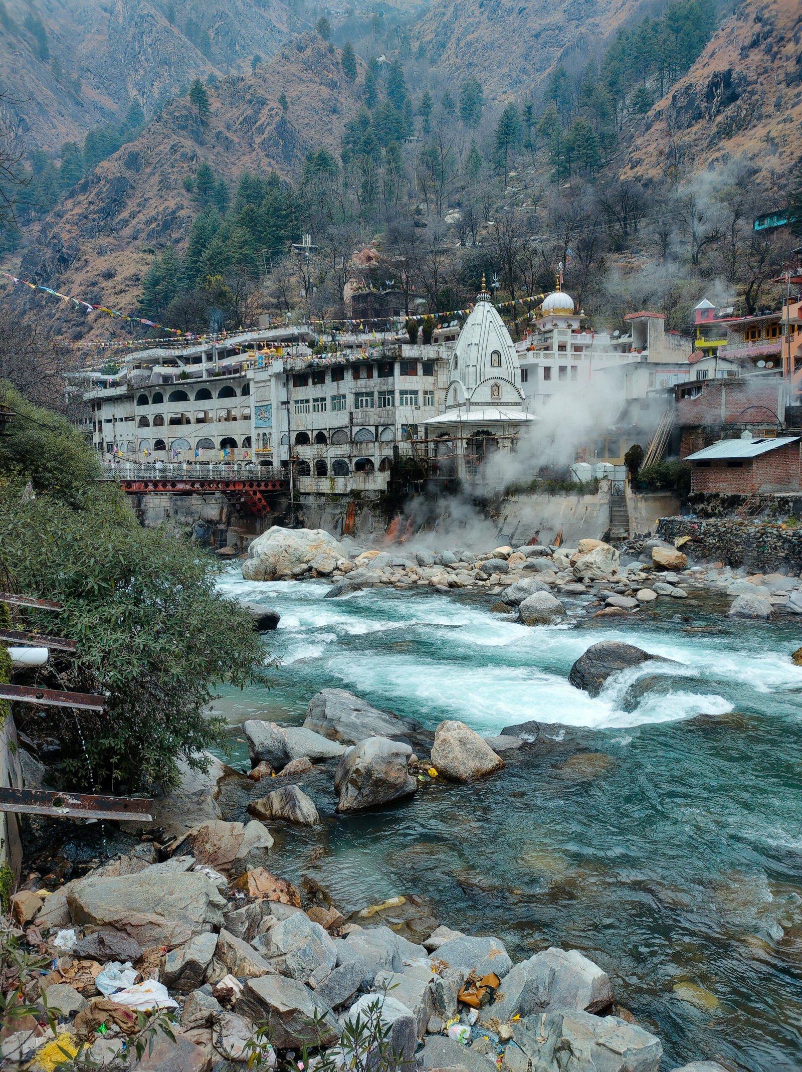 a river running through a town surrounded by mountains